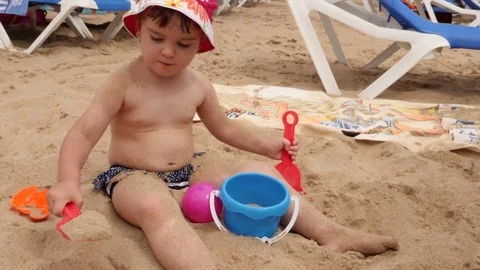 4K View Child Playing in Sand at Beach Happy Caucasian Little Girl 스톡 동영상 77636924