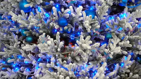 4K view of christmas tree decorated with blue balls and garlands. Stock Footage 120511388