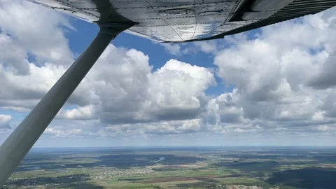 4K View on clouds and land from small airplane. Stock Footage 154932379