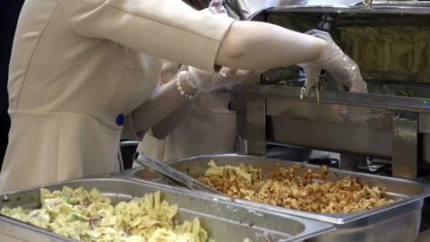 4K view of the cook puts delicious pasta in trays in a plate. Stock Footage 98367007