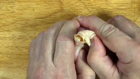 4K view of the cook’s hands divide a raw head of garlic into cloves. Stock Footage 134290304
