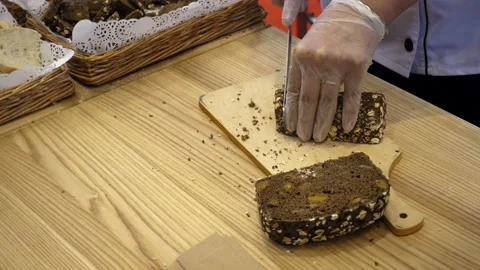 4K view of cutting a black bread Stock Footage 93585214