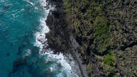 4K view directly above rocks, surf and cliff face on Lord Howe Island, Australia Stock Footage 93345027