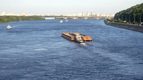 4K view of the Dnieper with a floating barge and city skyline. Stock Footage 127177969