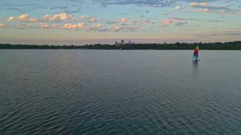 4K View From Drone Flying Past Sailboat On Lake Calhoun Minneapolis At Sunset Stock Footage 220469515