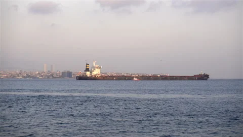 4K view of a dry cargo ship moving on water with views of Istanbul Stock Footage 117342863