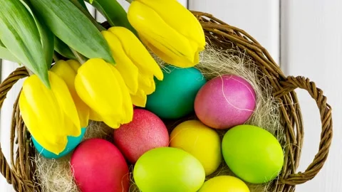 4K view of Easter eggs in a basket with tulips. Stock Footage 233148532
