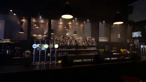 4K View Of Empty Bar In City Stacked With Bottles &amp; Draught Beer Pumps. No Peopl Stock Footage 75596169