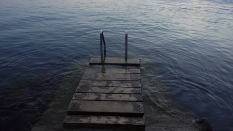4k view of the evening quiet sea and handrails for the descent into the sea Stock Footage 114301161