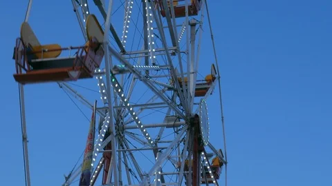 4K view of Ferris Wheel rides rotating, spinning in amusement park Stock Footage 108311225
