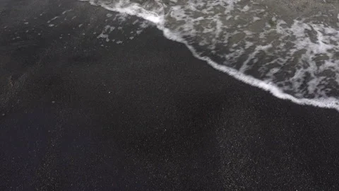 4K view of the foamy wave running onto the coastal sand. Stock Footage 117340046