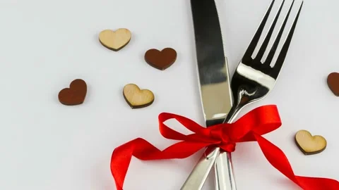 4K view of fork and knife decorated with red ribbon Stock Footage 236090566