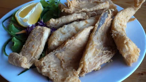 4K view fork takes fried fish from a plate Stock Footage 126788201