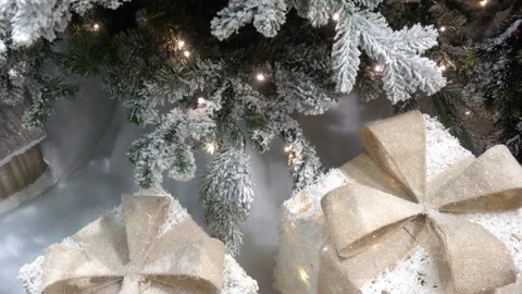 4K view of gift-shaped lights under the Christmas tree Stock Footage 213353088