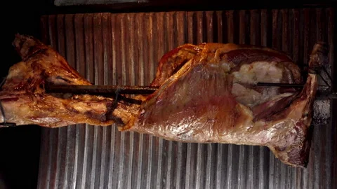 4K view of grilled lamb grill rotates on a spit. Stock Footage 92361070