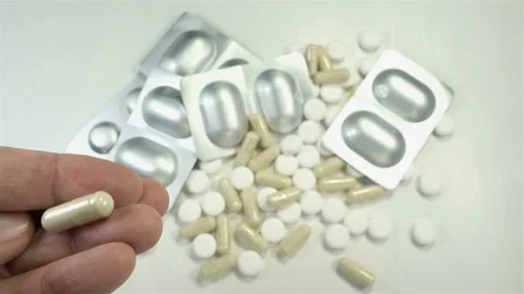 4K view of a hand holding a pill and dropping it Stock Footage 140724645