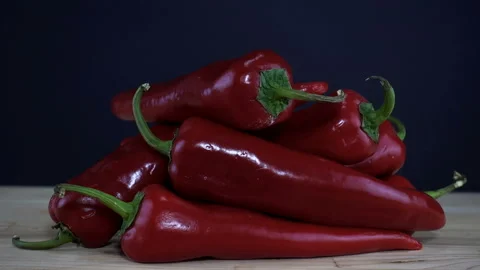 4K view hand takes red pepper from heap vegetable Stock Footage 131085932