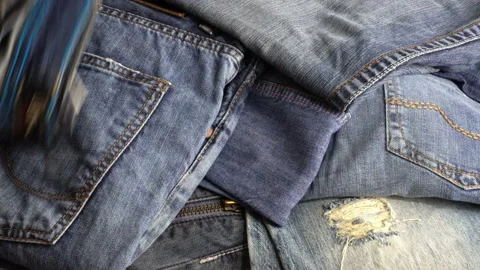 4K view of a hand taking jeans Stock Footage 129567436