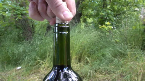 4K view of a hand taking out a cork from a wine bottle Stock Footage 154856974