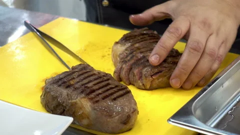4K view of the hands of the chef cutting the fried meat into pieces Stock Footage 92815636