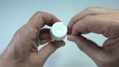 4K view of hands opening a lid on medical can Stock Footage 143162646