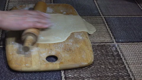 4K view of hands rolling dough with a rolling pin Stock Footage 123841509