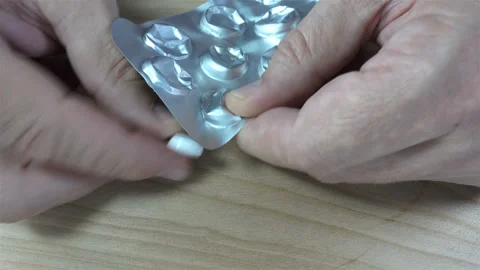 4K view of hands taking out a pill from a blister Stock Footage 140169252