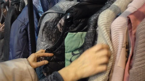 4K view of hands touching women's clothes on hangers Video stock 124524786