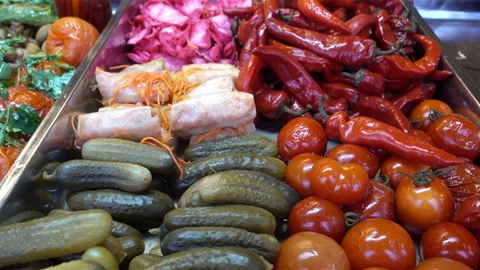 4K view of heaps of pickled tomatoes, cucumbers, peppers Stock Footage 135732656