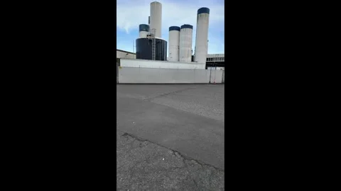 4K view of industrial dairy processing facility with storage tanks and silos Stock Footage 331636885