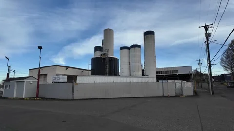 4K view of industrial dairy processing facility with storage tanks and silos 스톡 동영상 331636892