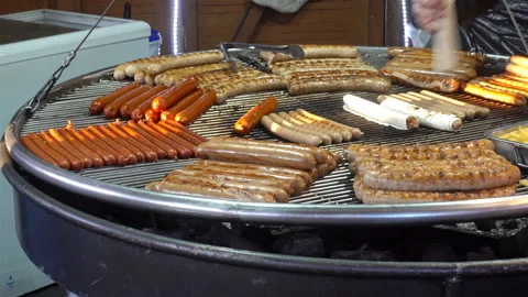 4K view of a large round grill with sausages. Stock Footage 124794676