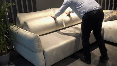4K view of a man folding a sofa bed. Stock Footage 196066017