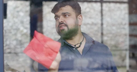 4K View from outside looking in, man cleaning windows in large modern building Stock Footage 101419533