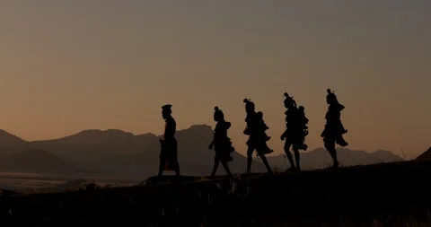 4K view of people from the Himba tribe in traditional dress, walking along a Stock Footage 95211546