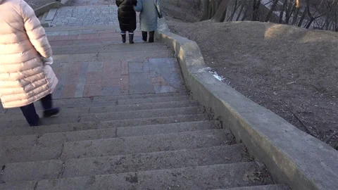4K view of people walking down a staircase in a park Stock Footage 123842970