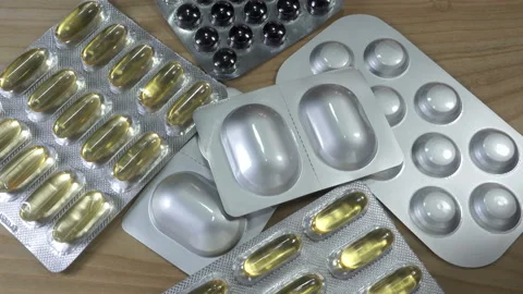 4K view of pills in blisters falling on drugs Stock Footage 140163962