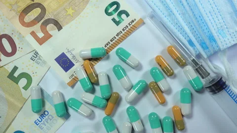 4K view of pills falling on euro bills with medical masks and syringe Stock Footage 132408833