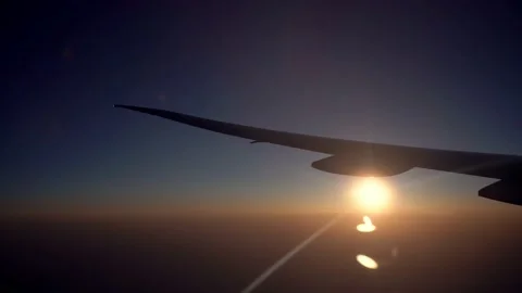 4K, View of plane wing with the sunset through an airplane window in flight-Dan Stock Footage 134280330