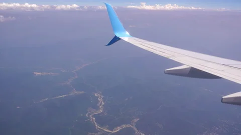 4K, View of plane wing through an airplane window in flight trip, traveling by Stock Footage 138749849