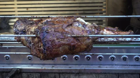 4K view of pork leg roasts rotates on the grill. Stock Footage 101034281