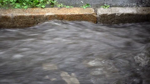 4k view of the rapid flow of water along the road Stock Footage 109231837
