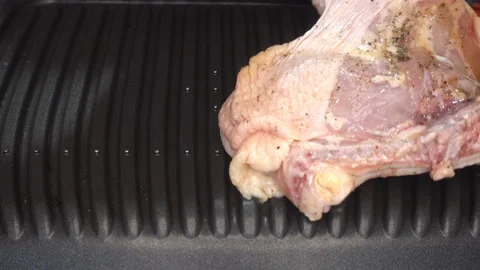 4K view of raw chicken leg put on the grill Stock Footage 199679697