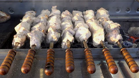 4K view of raw kebabs rotate on the grill. Stock Footage 128115288