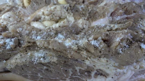 4K view of raw meat being poured with salt. Stock Footage 140190228