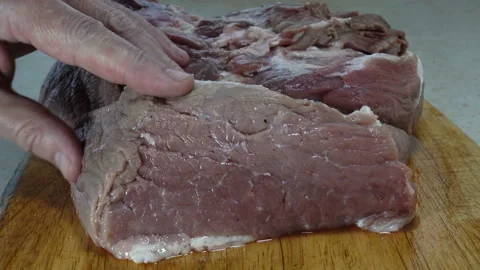 4K view of a raw meat is pierced with a knife. Stock Footage 131940239