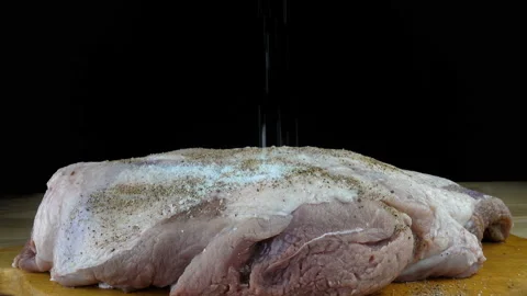 4K view of a raw meat sprinkled with pepper Stock Footage 213337571