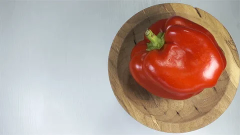 4K view of red bell pepper rotate on wooden plate Stock Footage 142732584