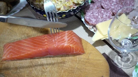 4k view of the red fish on the table with snacks. The cook cuts red fish Stock Footage 84085949
