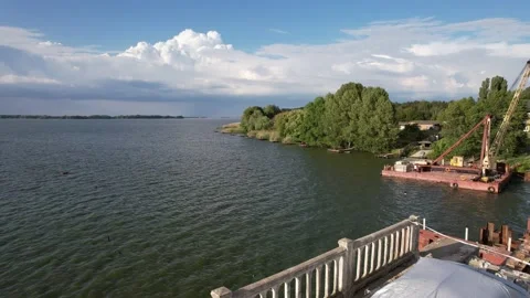 4K View of the river across which the construction of a new bridge Stock Footage 155328767